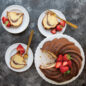 Baked Swirl Bundt cake cut into slices topped with strawberries