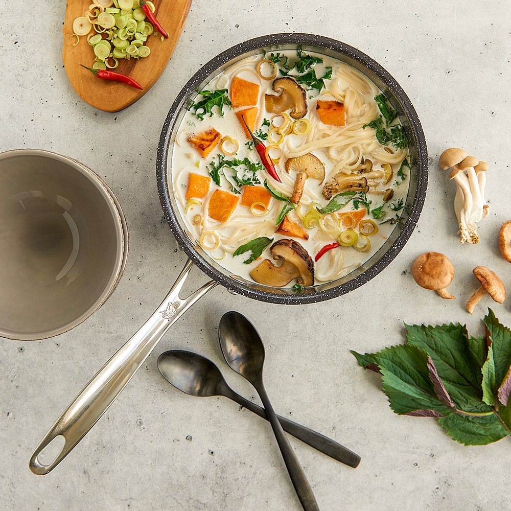 Image of coocnut soup with veggies and noodles in Basalt Sauce Pan overhead